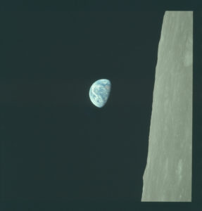 Earthrise. An image of Earth rising past the horizon of the moon.