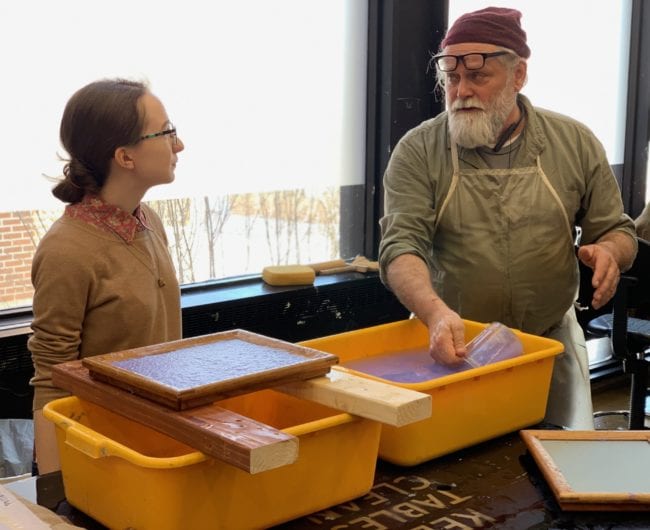 Master Papermaker Robert Possehl teaching a student how to make paper. 